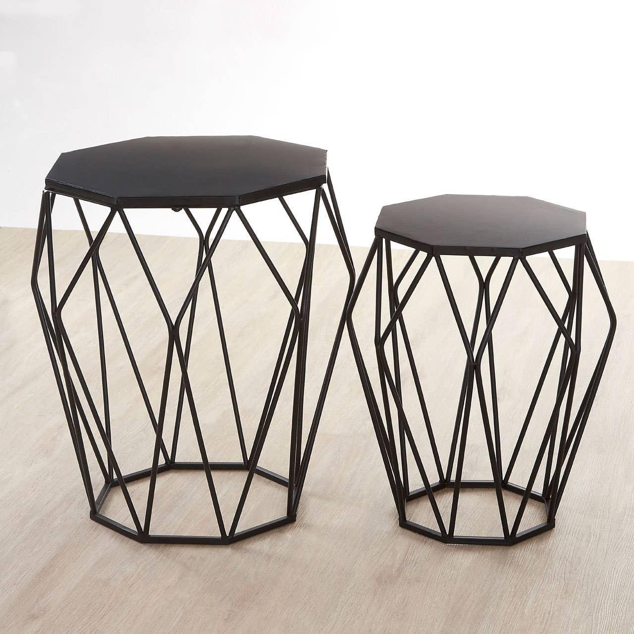 Set of two black metal geometric side tables with hexagonal tops on light wood floor