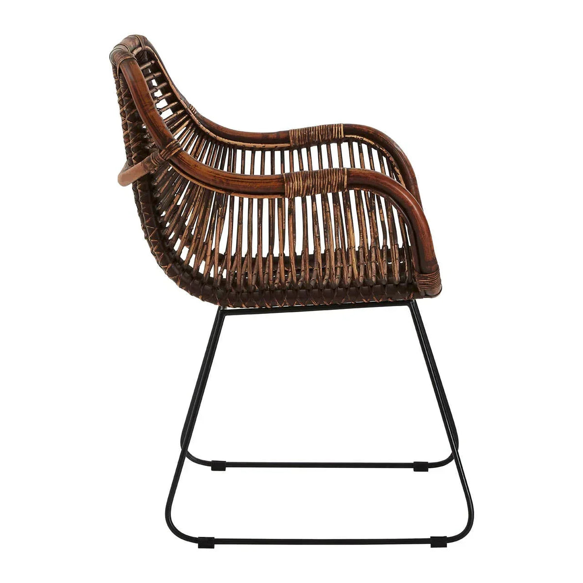 Side view of brown rattan dining chair with metal legs and curved armrests