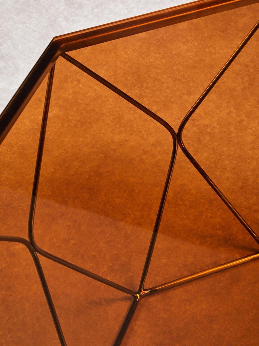 Geometric copper glass coffee table top with metal frame, close-up detail view