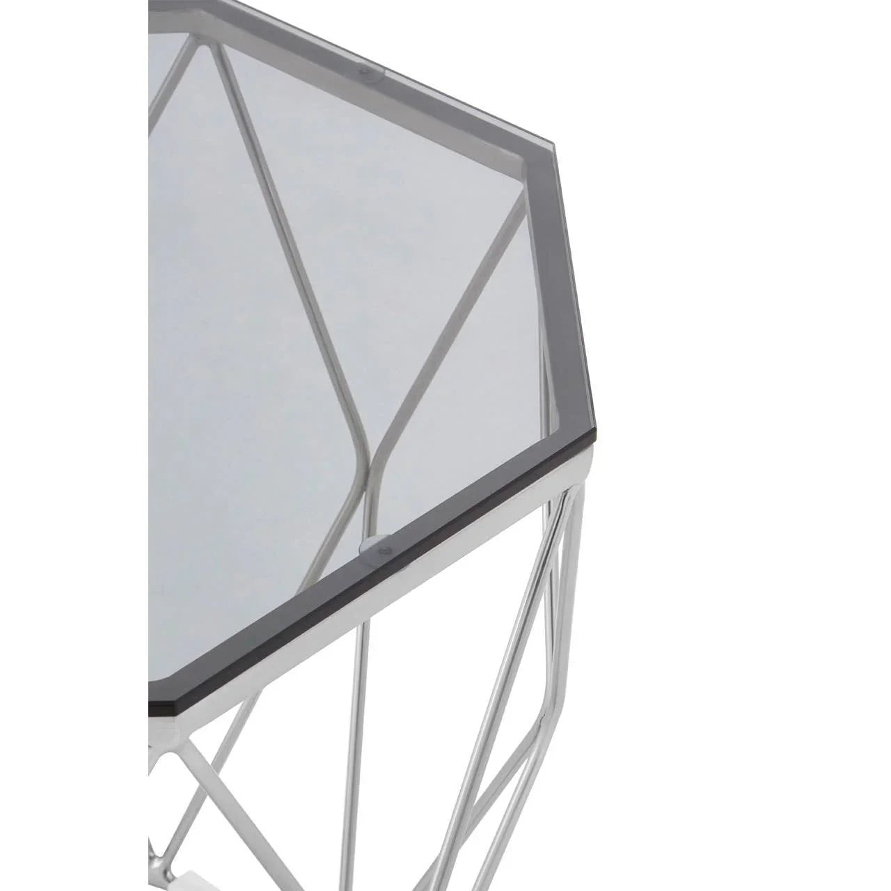 Hexagonal glass side table with silver metal geometric frame, close-up of tabletop