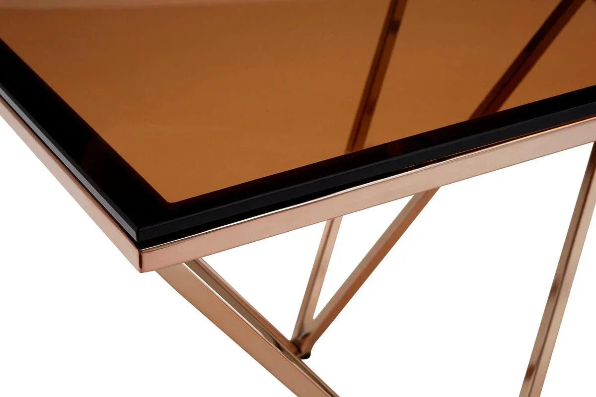 Copper glass coffee table with metal frame and angled legs, close-up corner detail