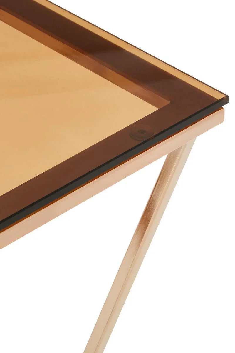 Closeup of glass top table with wooden legs and amber tinted edge detail