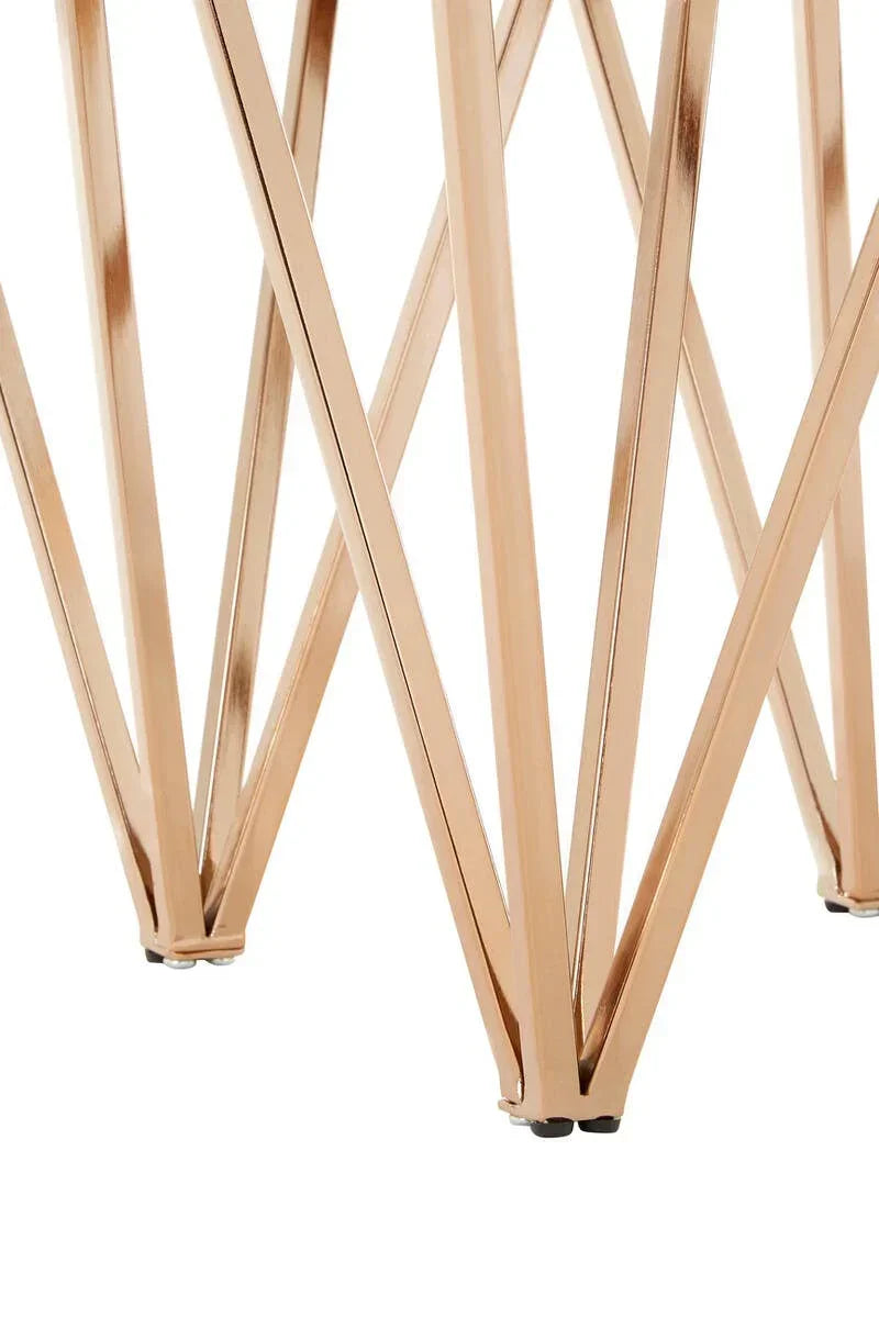 Gold metal table legs with geometric crisscross design, close-up view