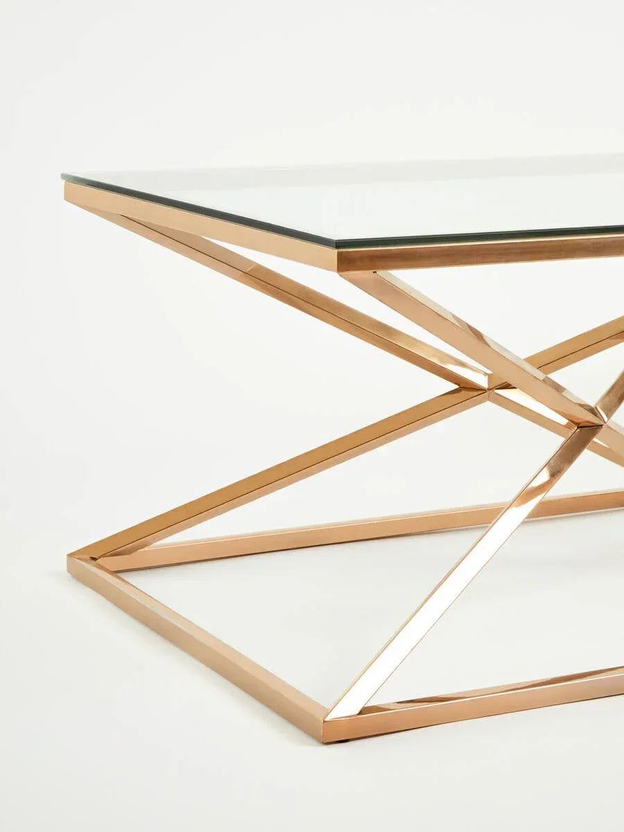 Glass coffee table with gold metal geometric base, close-up on corner and frame