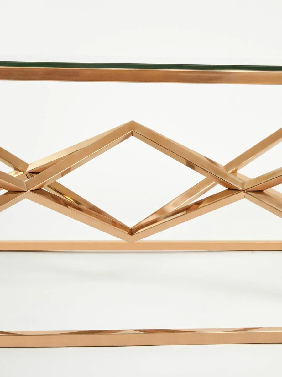 Gold metal console table with geometric frame and glass top