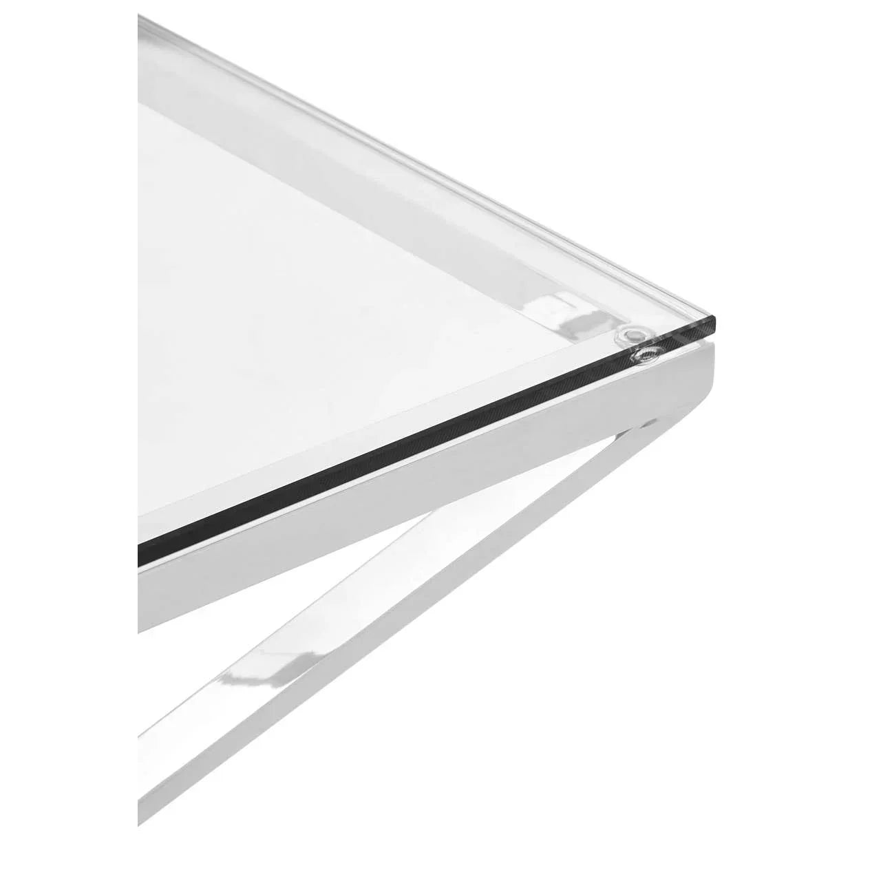 Close-up of glass coffee table corner with chrome metal frame