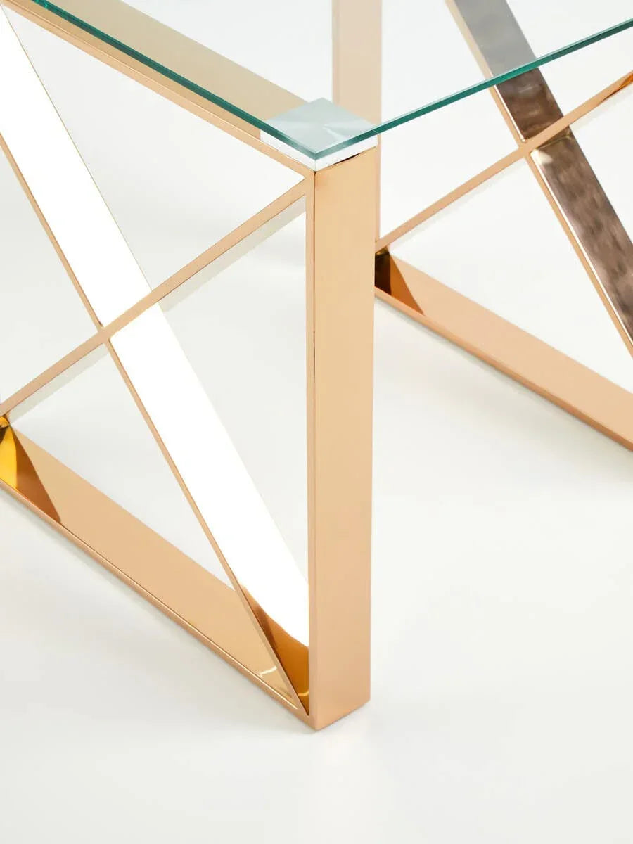 Modern glass coffee table with gold metal frame and geometric base detail