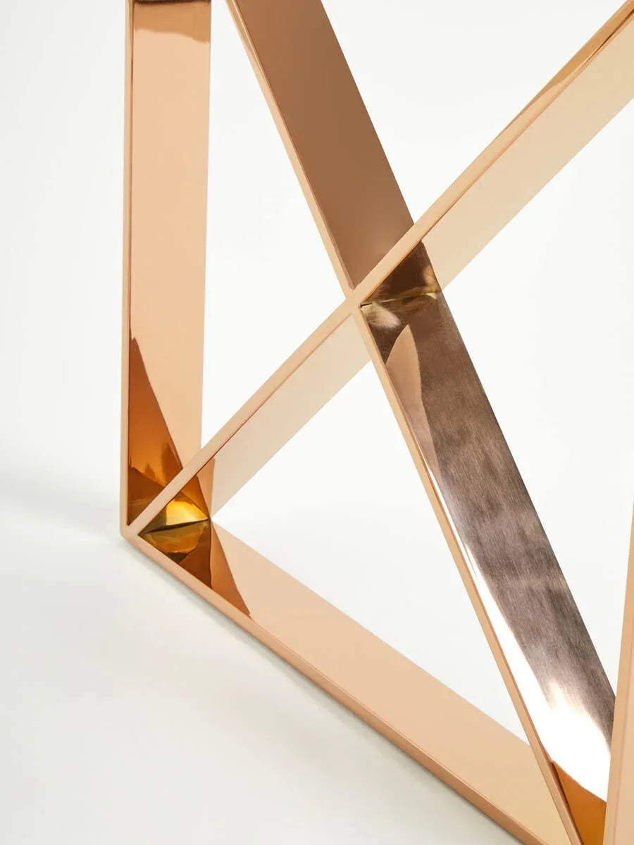 Close-up of gold metal table frame with geometric cross design