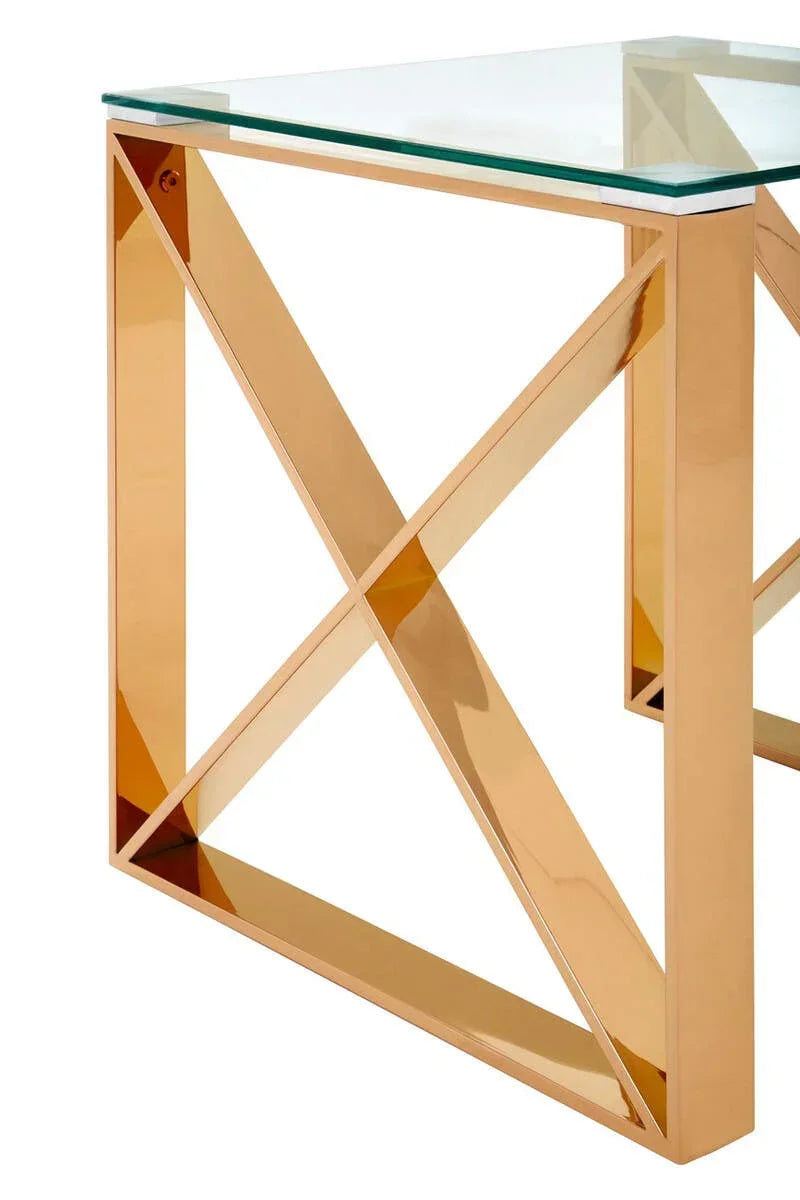 Glass top table with gold metal frame and cross design, modern furniture close-up view