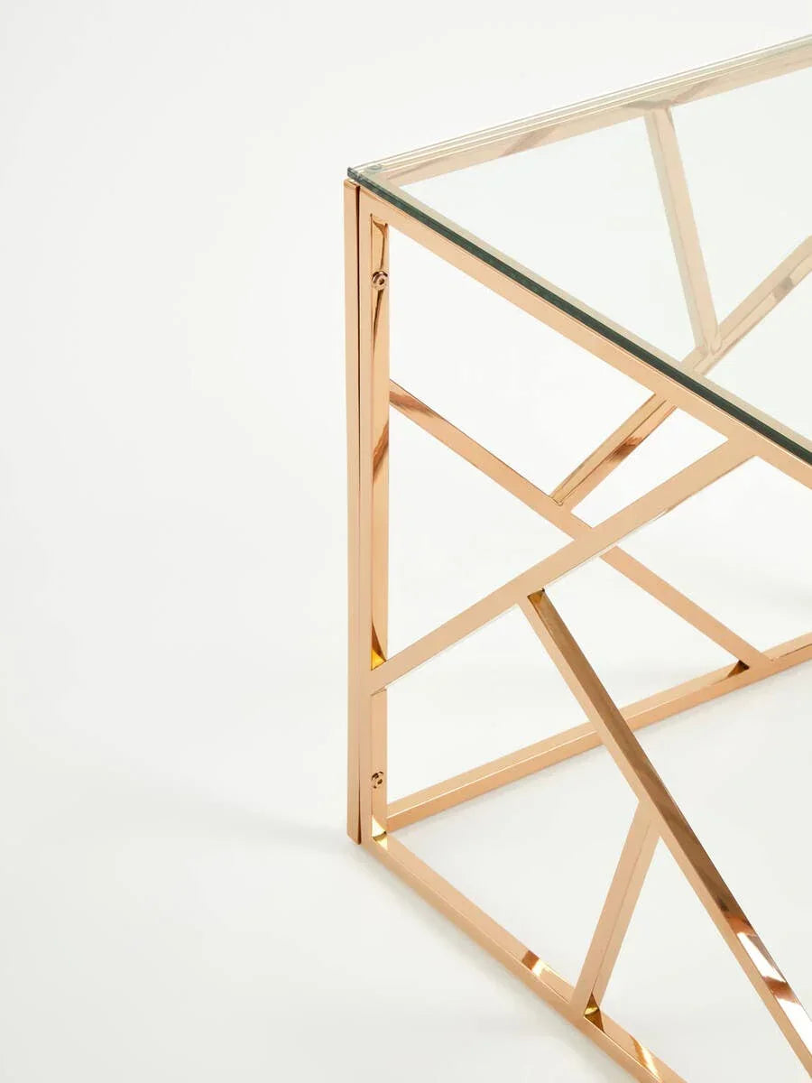 Glass coffee table with gold metal geometric frame, close view of corner and leg design