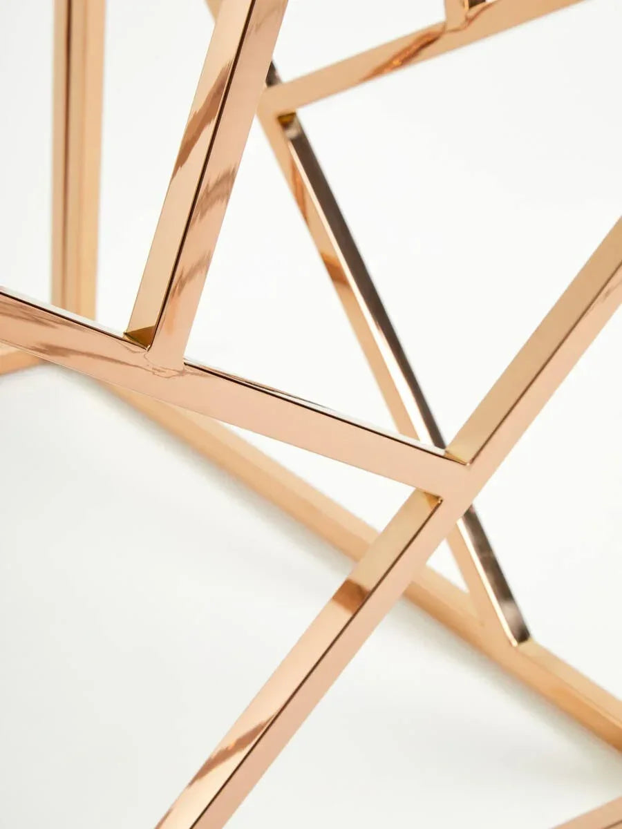 Close view of rose gold metal table legs with geometric design