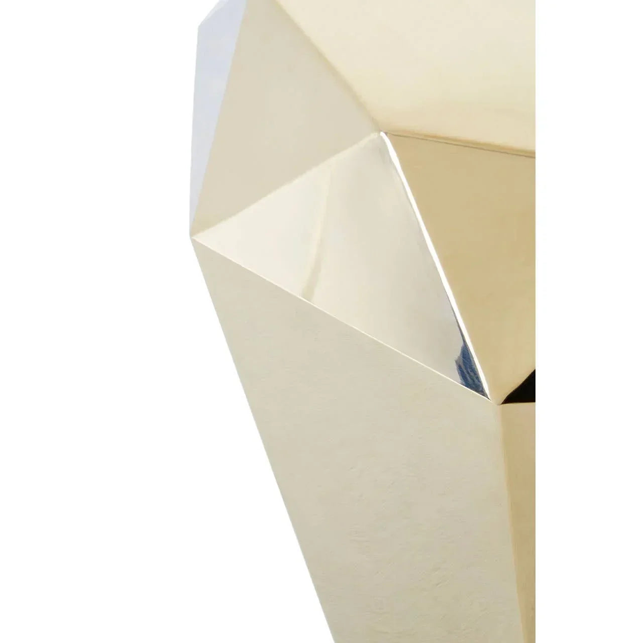 Close-up of gold faceted metal table corner with geometric design