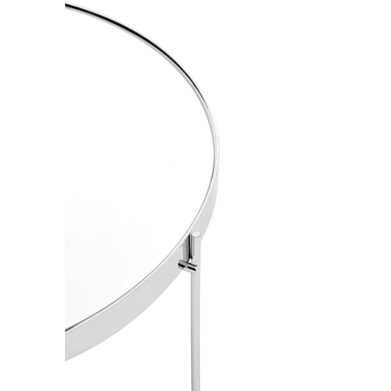Close-up of round glass side table with chrome metal frame and leg detail