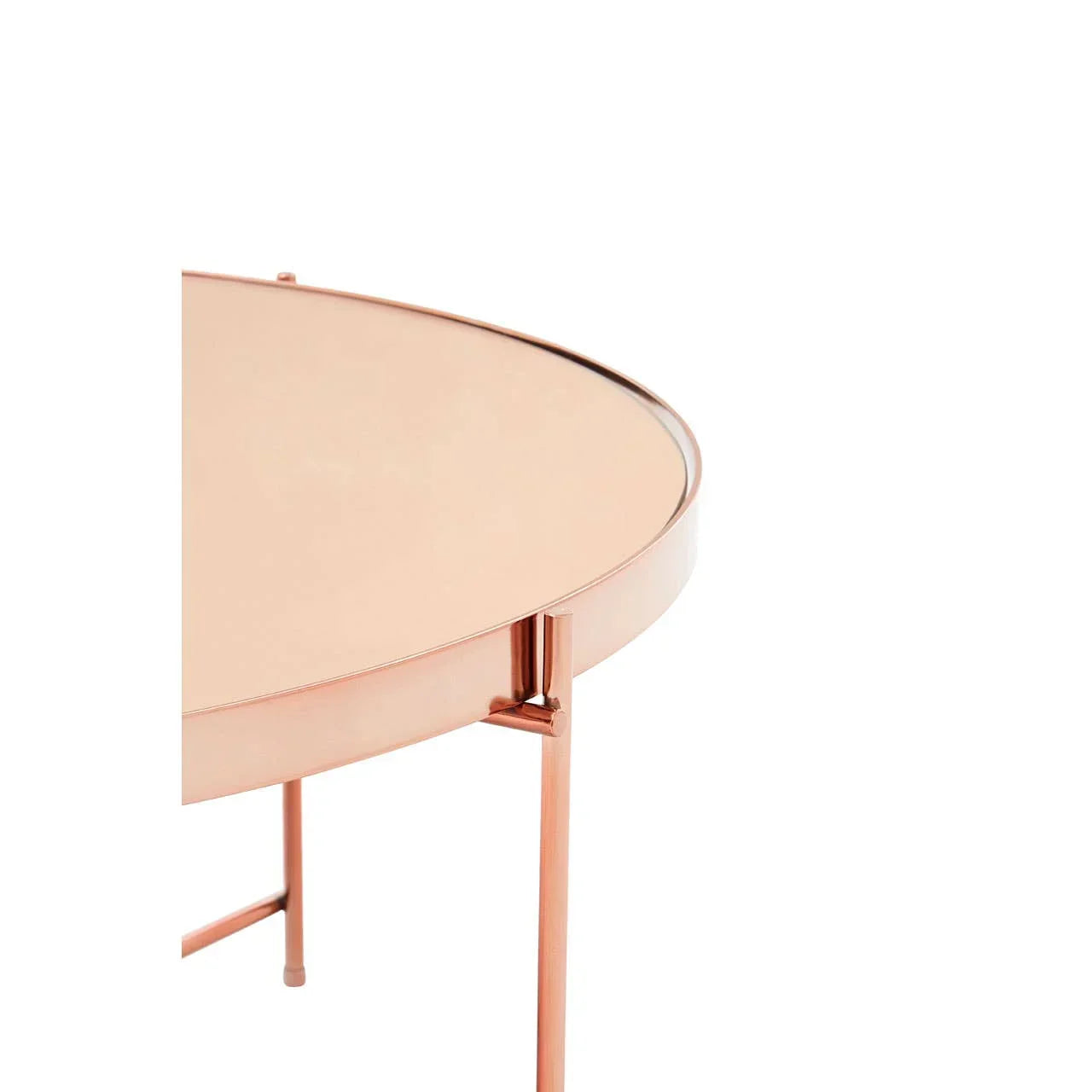 Round copper side table with mirrored top and slim metal legs, partial close-up view
