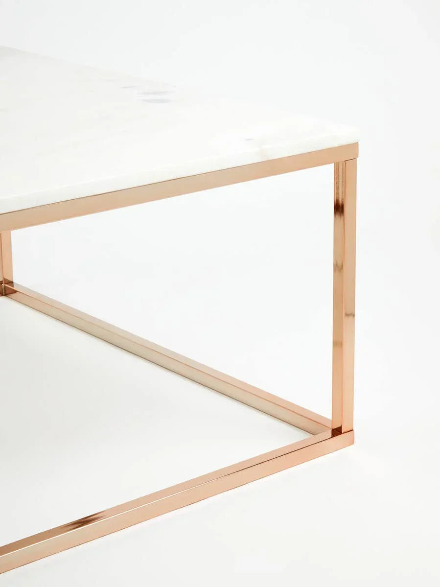 Marble coffee table with rose gold metal frame, close-up on corner detail