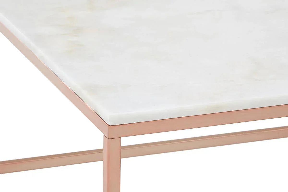 Marble top table with rose gold metal frame, corner detail view