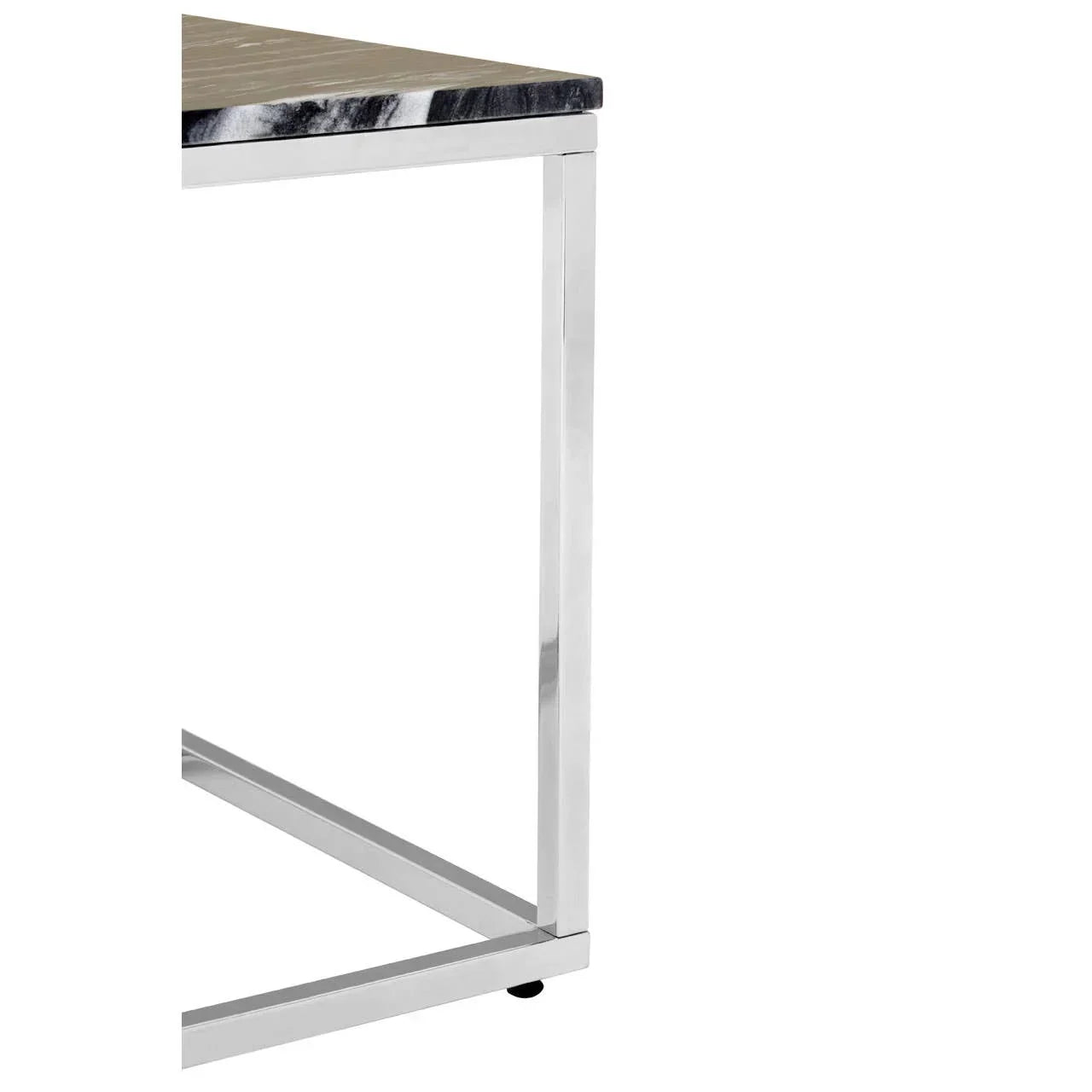 Corner detail of modern dining table with black marble top and chrome metal legs