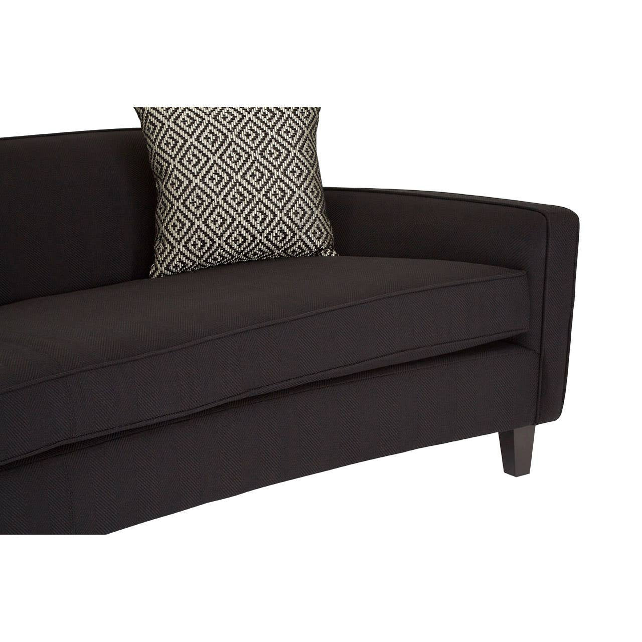 Three-seat sofa upholstered in black dimity fabric, featuring a sleek, curved design and wooden legs. A decorative cushion with a subtle pattern rests on one side, enhancing the modern aesthetic