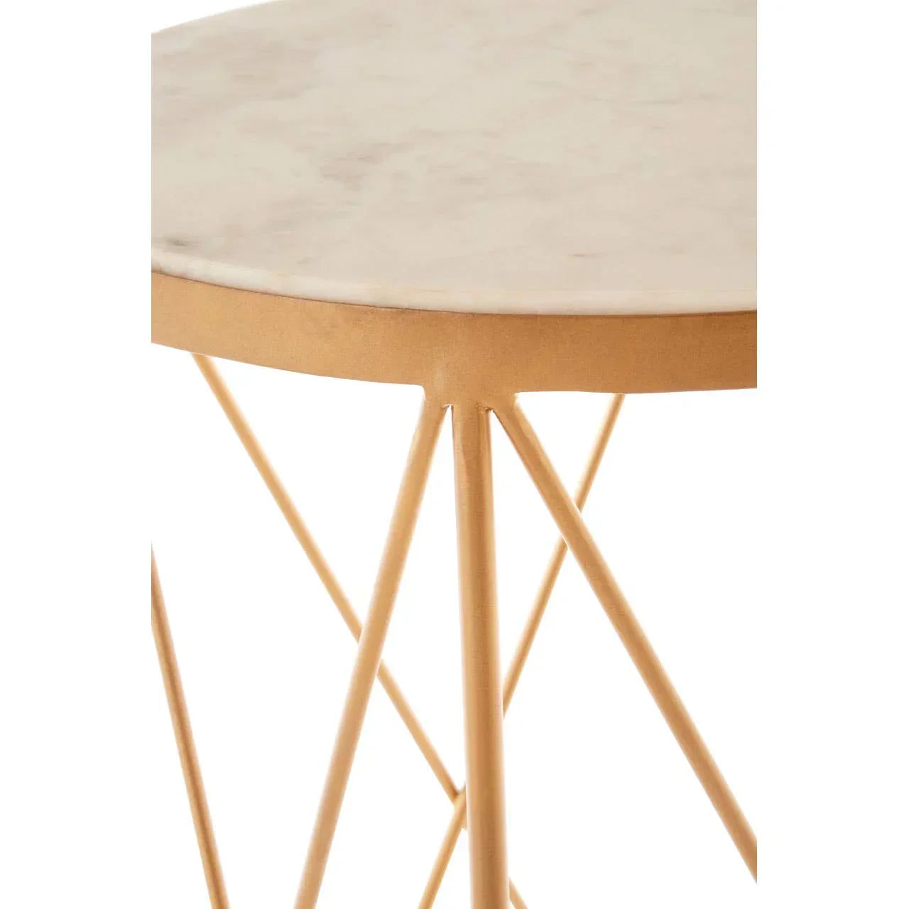 Round marble side table with gold metal base and angled legs, close-up of tabletop edge
