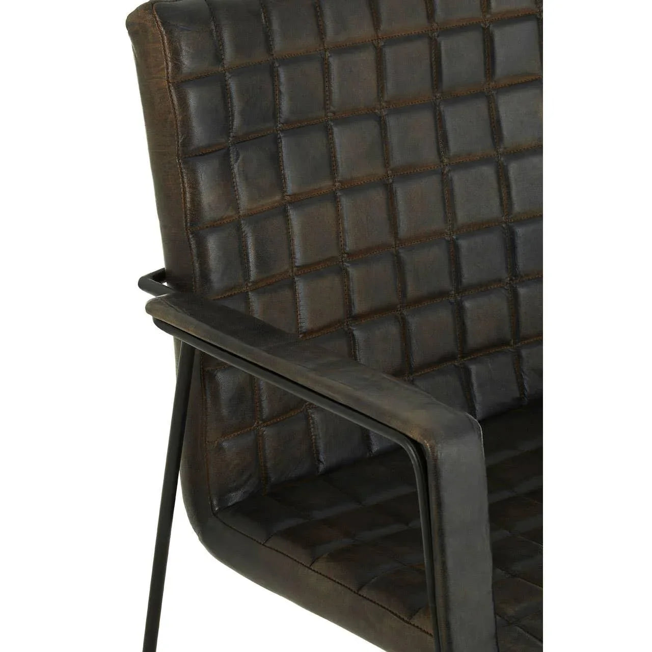 Close-up of brown leather armchair with quilted stitching and black metal frame