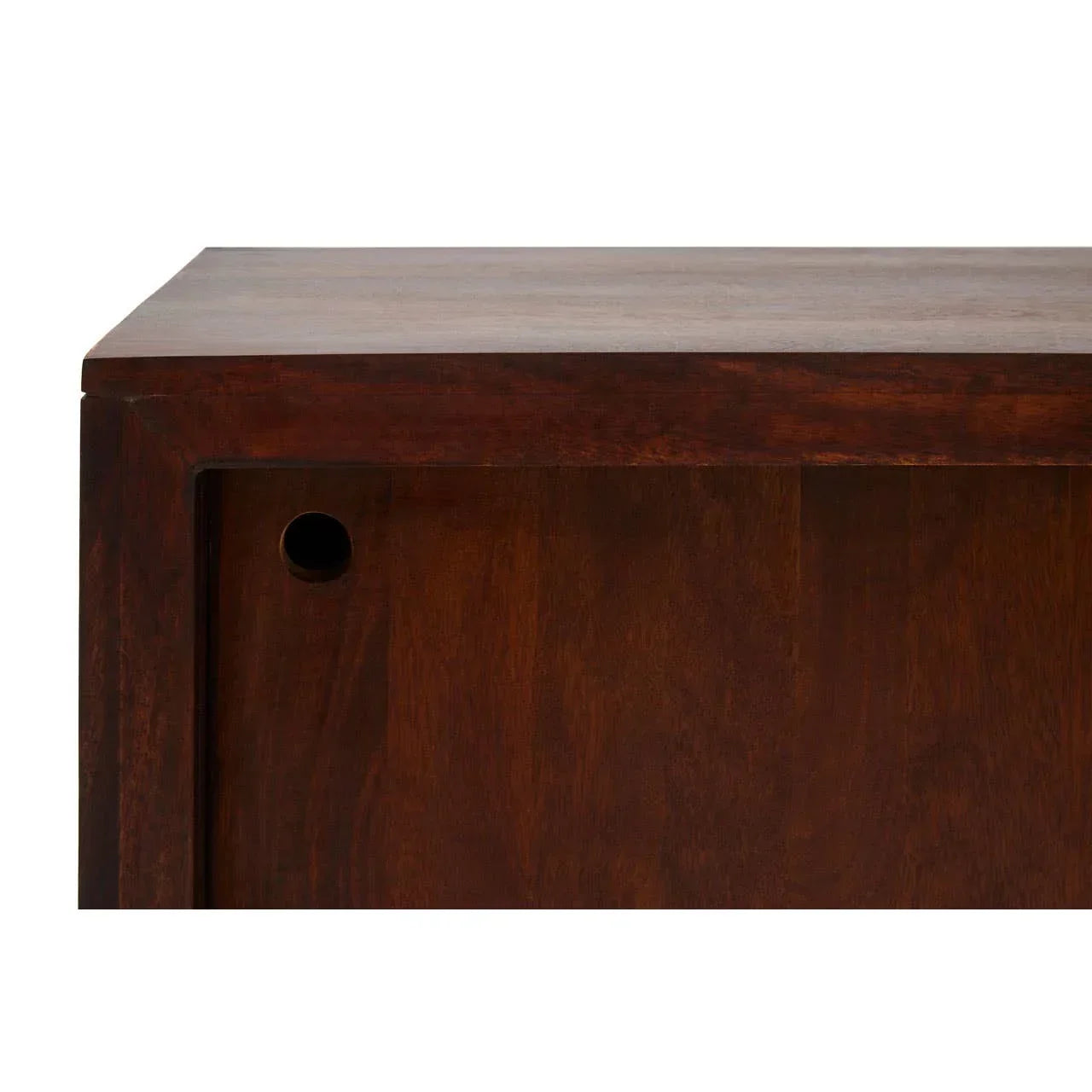 Close-up of solid wood cabinet corner with sliding door and round handle cutout