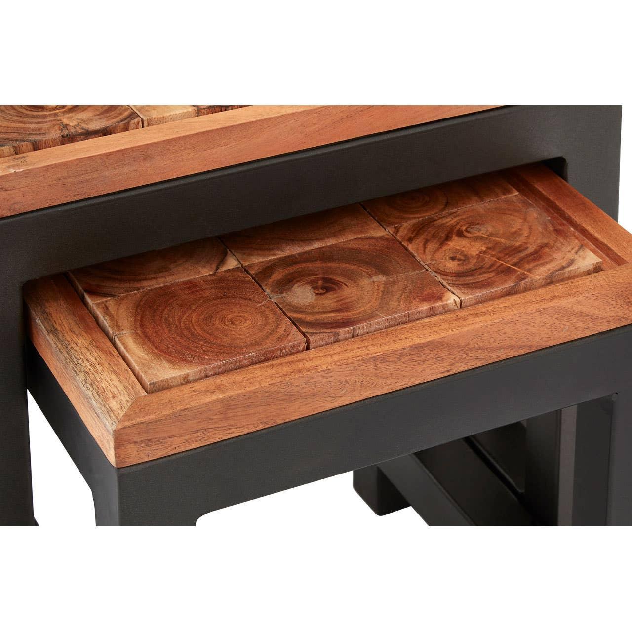 Close view of wooden nesting tables with natural grain and black metal frame