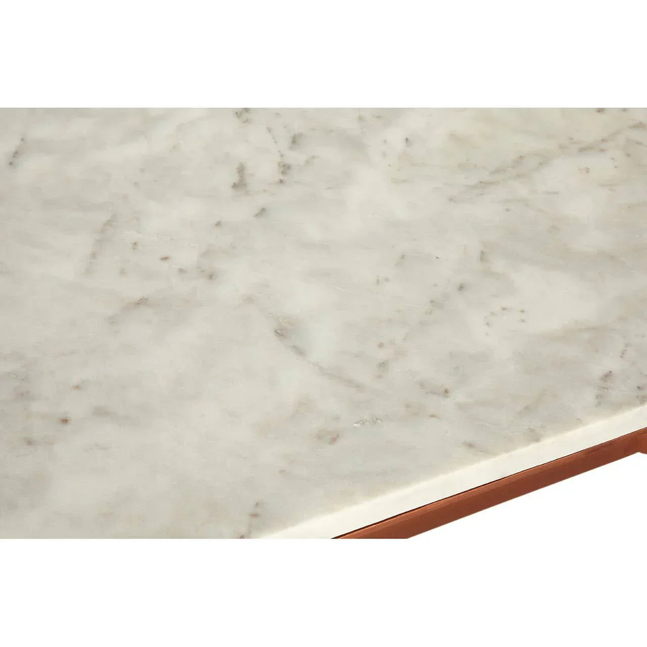 Closeup of white marble dining table top with subtle grey veining and beveled edge