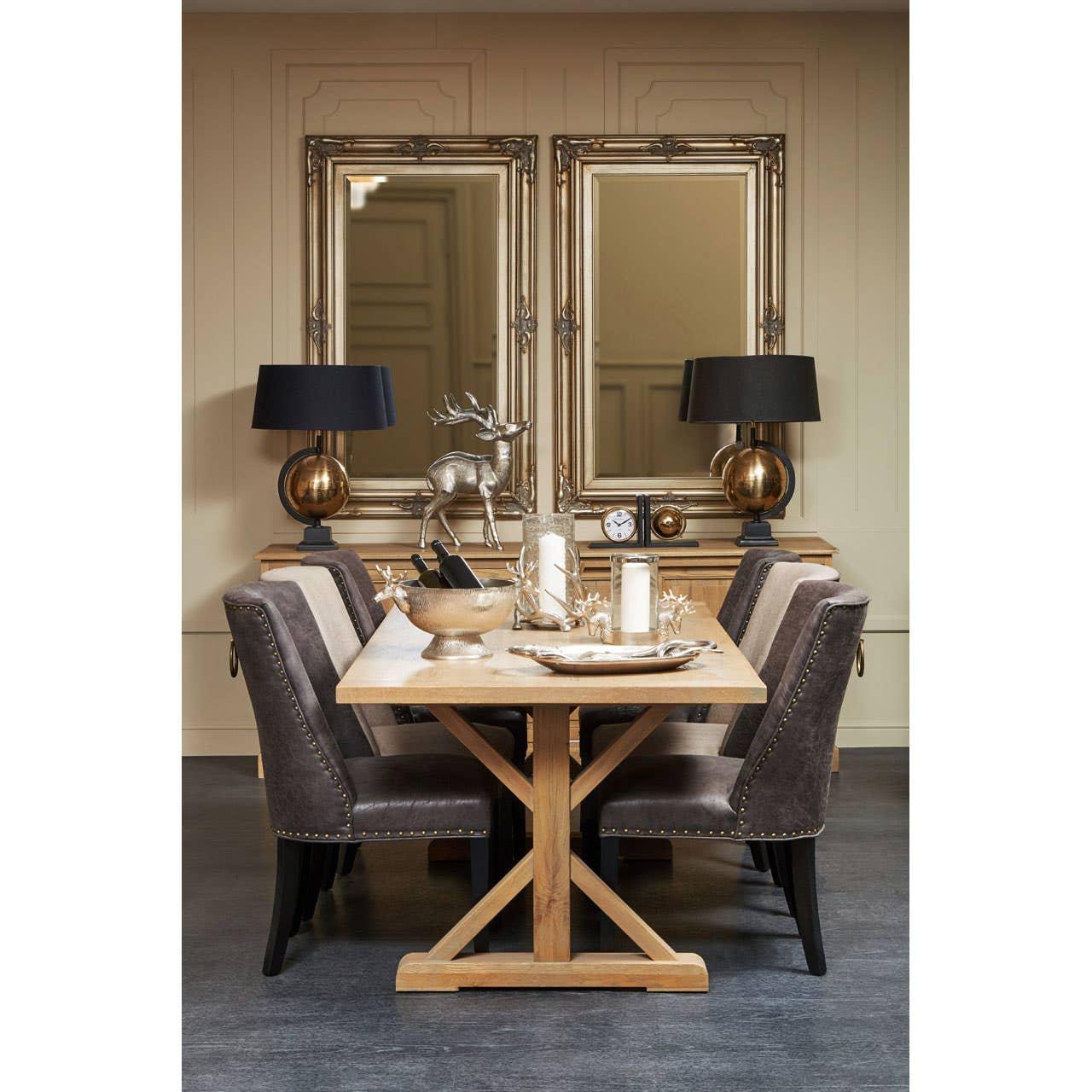 Oak dining table with grey upholstered chairs, gold accents and decorative mirrors