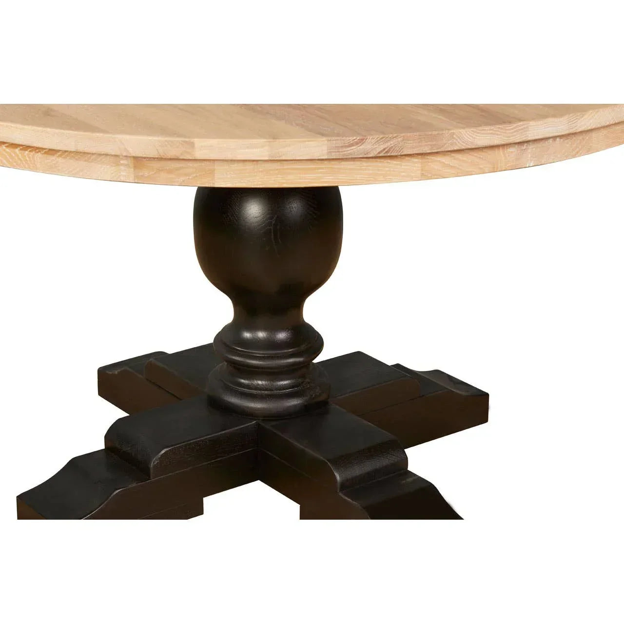 Round wooden dining table with natural top and black pedestal base close-up