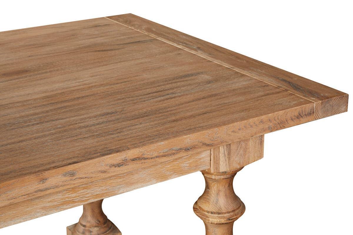 Corner view of wooden dining table with turned leg and visible wood grain texture