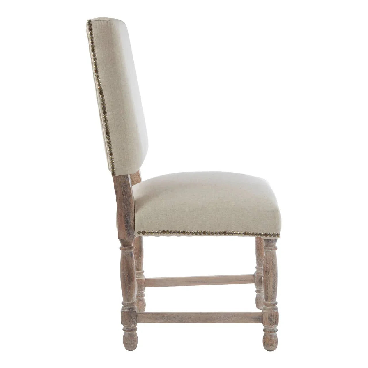 Side view of upholstered dining chair with light wood legs and brass stud detailing