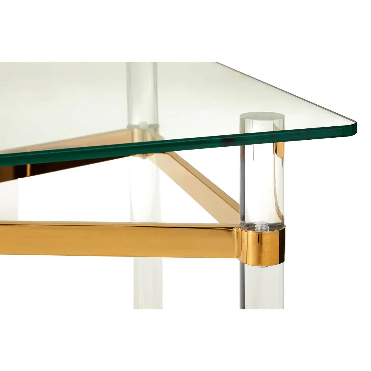 Glass coffee table corner with gold frame and clear acrylic leg detail