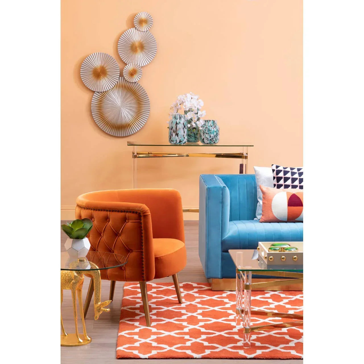 Velvet orange accent chair and blue sofa with patterned cushions in modern living room