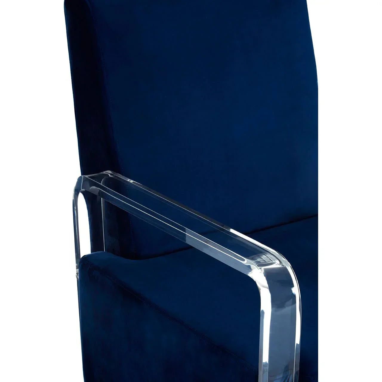 Navy blue velvet armchair with clear acrylic armrest close-up