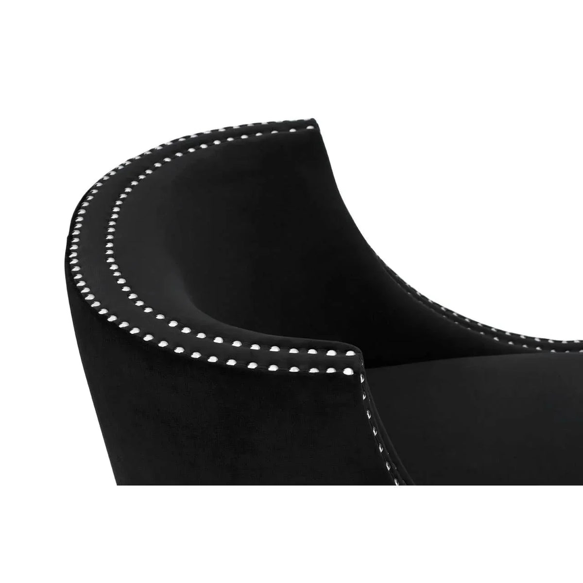 Black velvet accent chair with silver studded trim, close-up of curved backrest detail