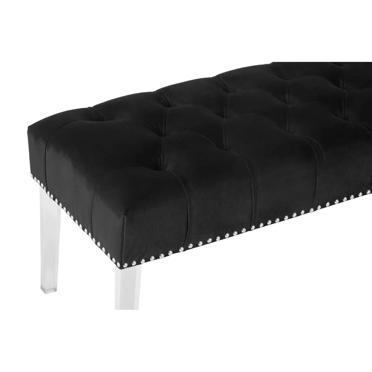 Black upholstered bench with button tufting, silver nailhead trim, and clear acrylic legs