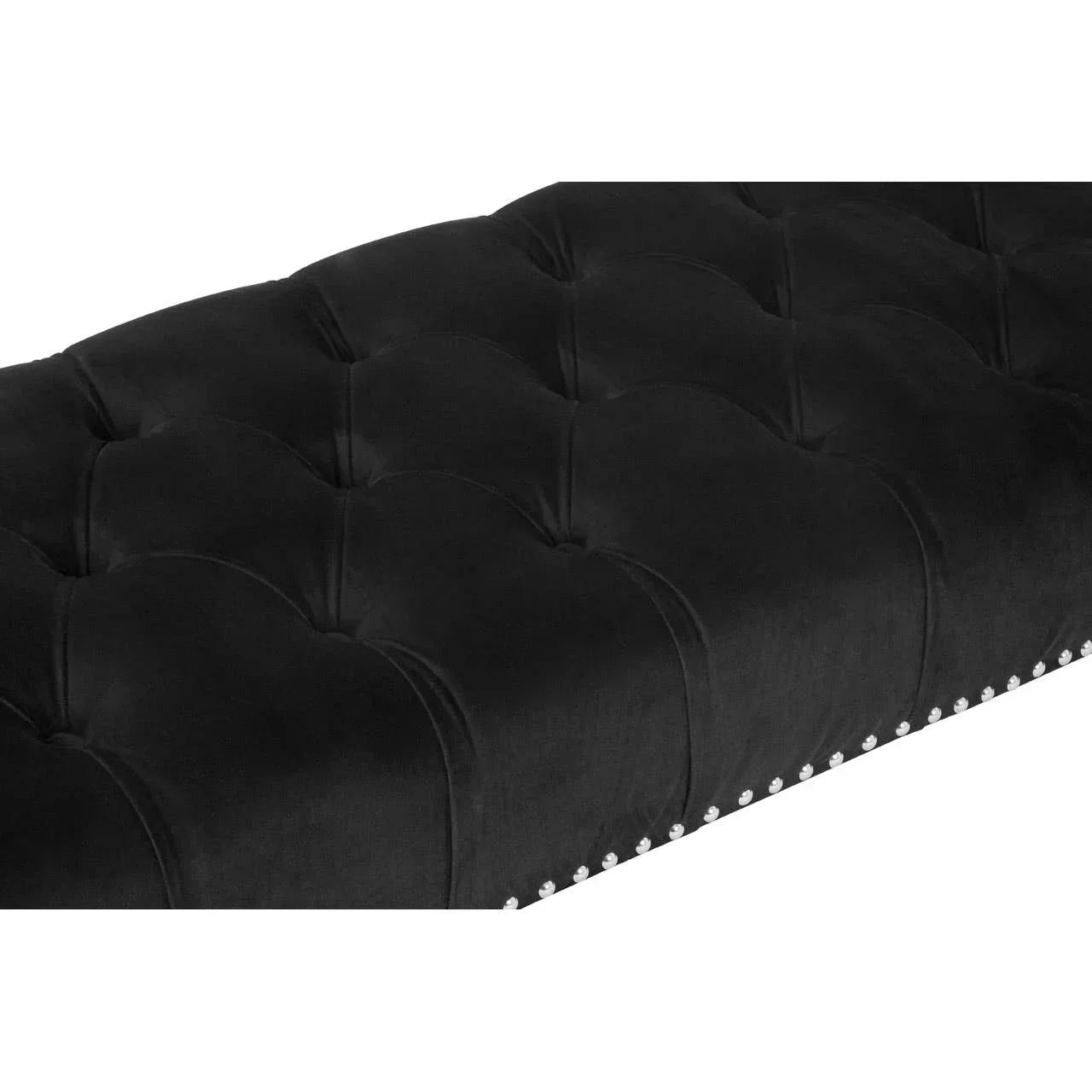 Black velvet upholstered bench seat with tufted detail and silver stud trim close-up