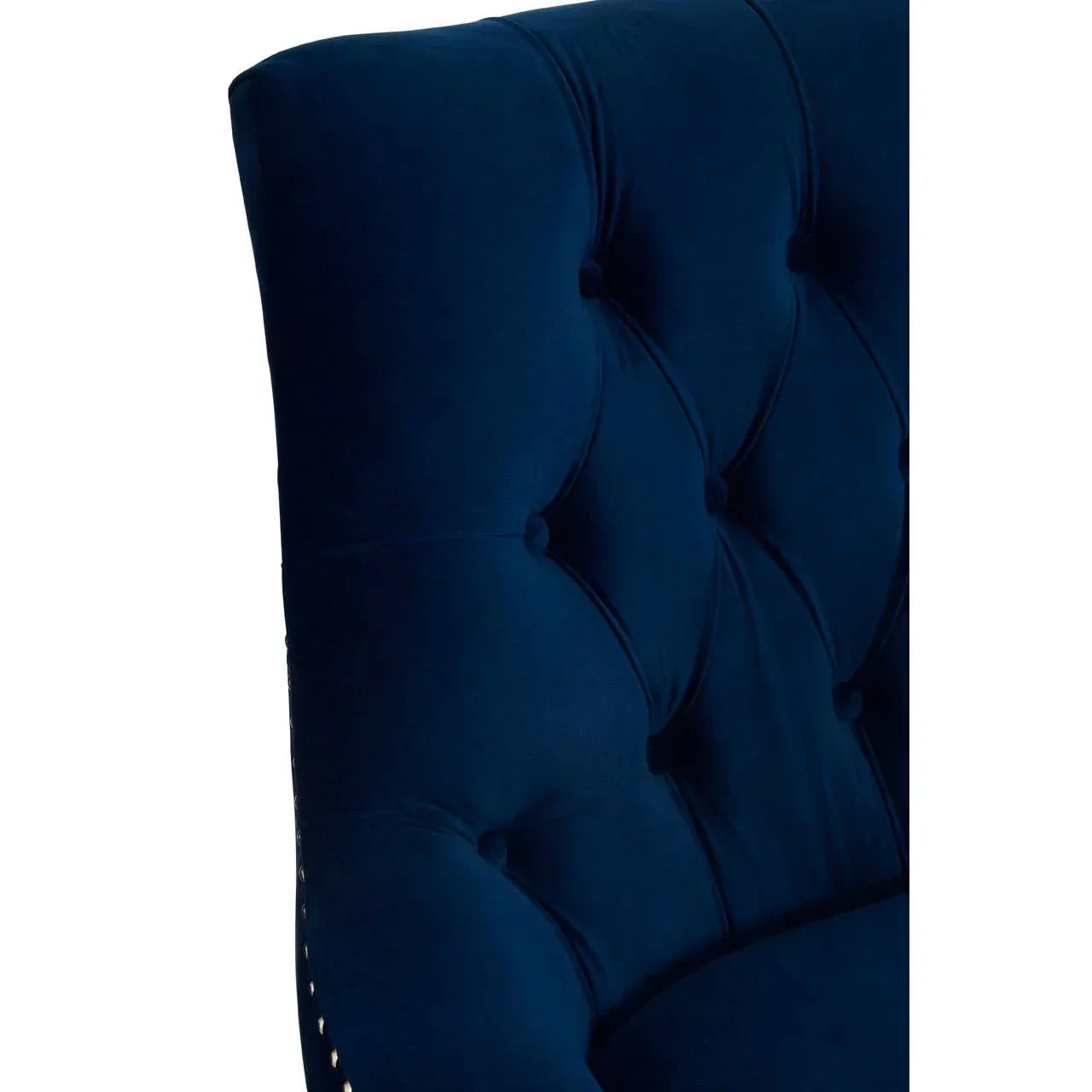 Navy blue velvet chair backrest with deep button tufting, shown from a side view