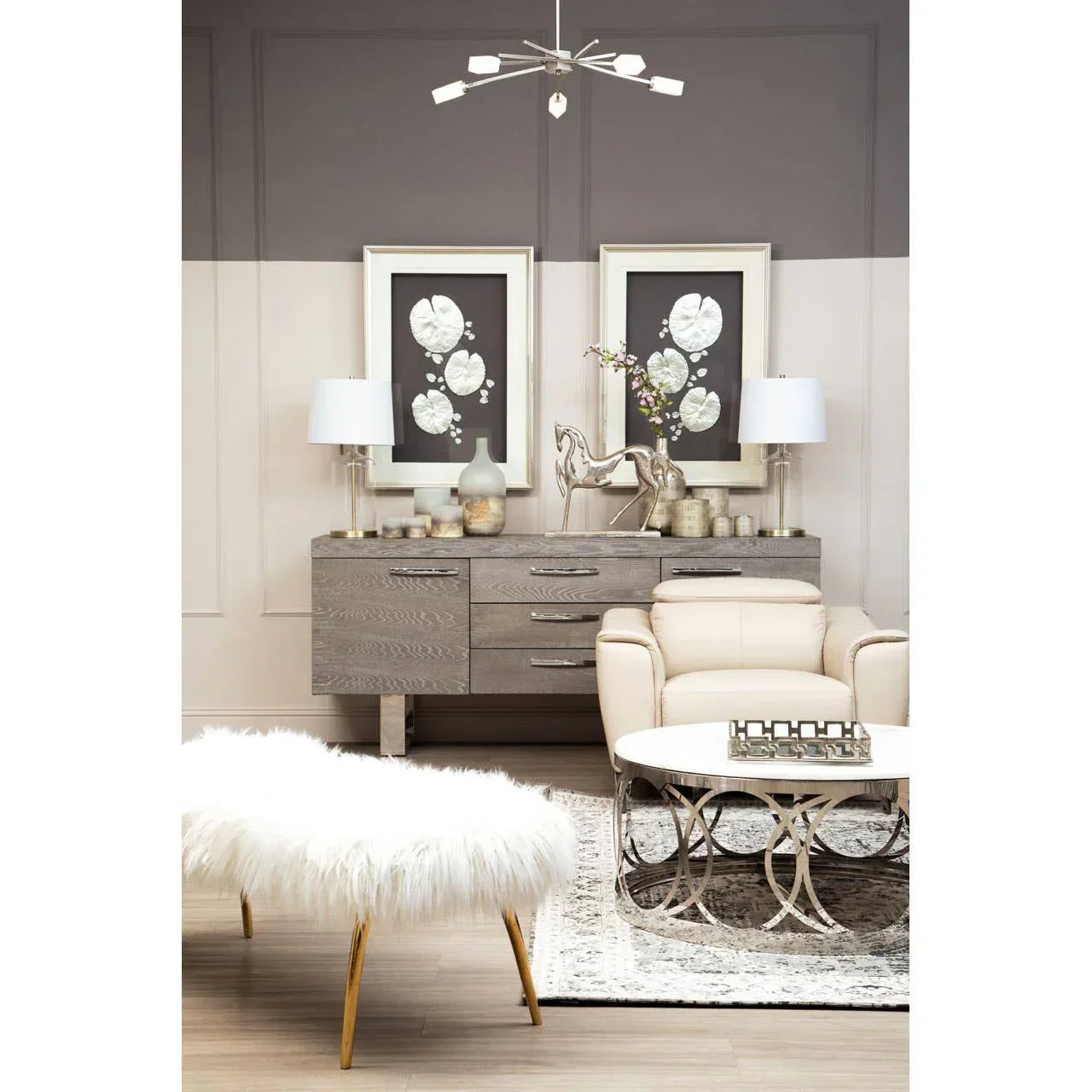 Modern living room with oak sideboard, cream armchair, round coffee table, and faux fur bench
