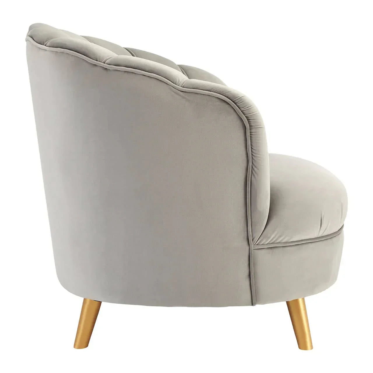 Grey velvet accent chair with curved back and gold tapered legs, side view