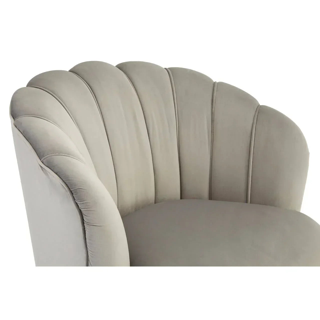 Grey velvet armchair with scalloped backrest and soft cushioned seat, close-up view
