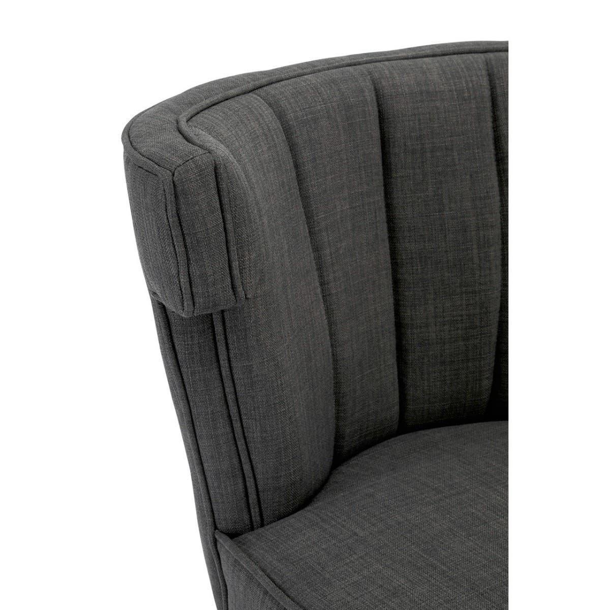 Close-up of dark grey fabric armchair with vertical stitched padded backrest
