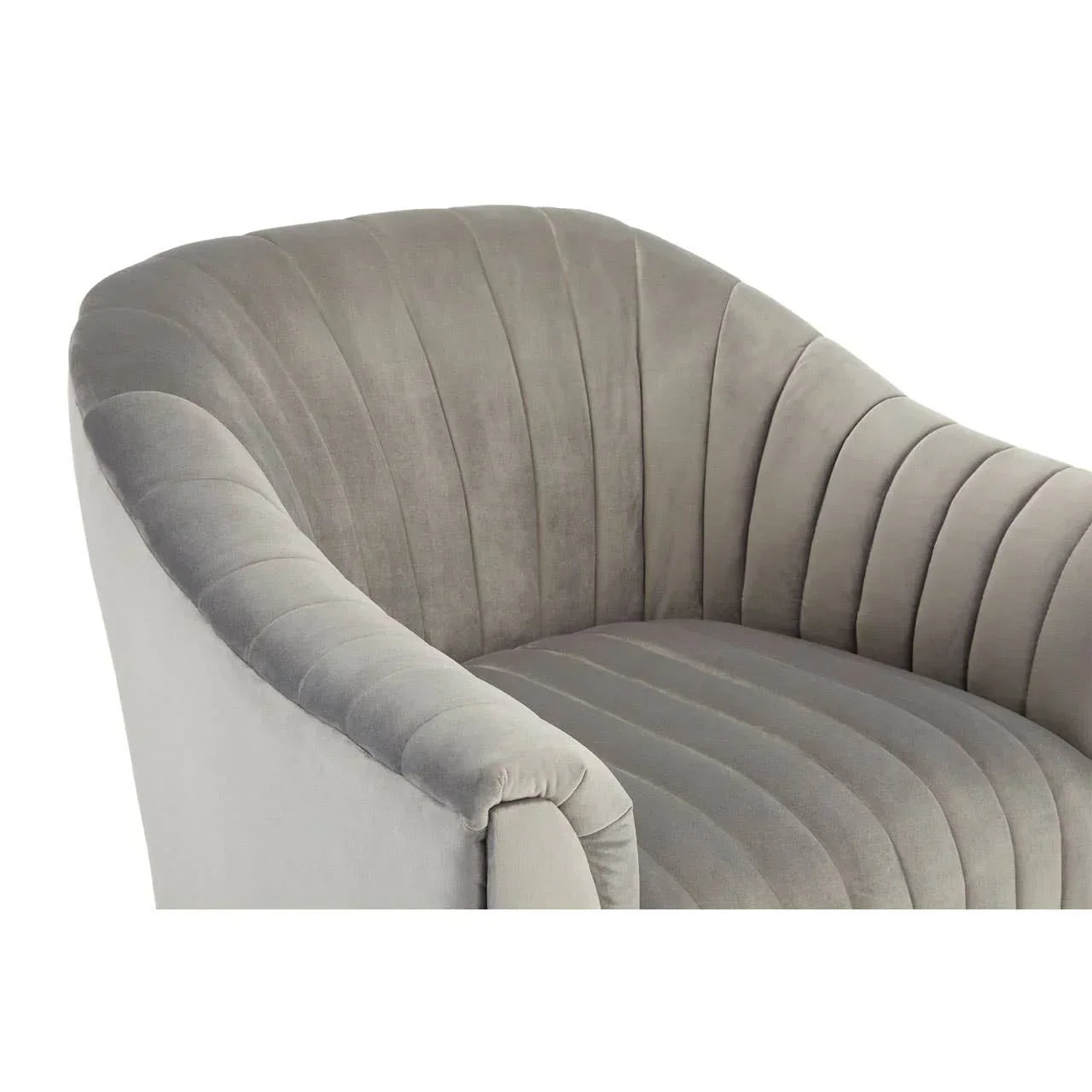 Grey velvet armchair with curved backrest and vertical stitched detailing