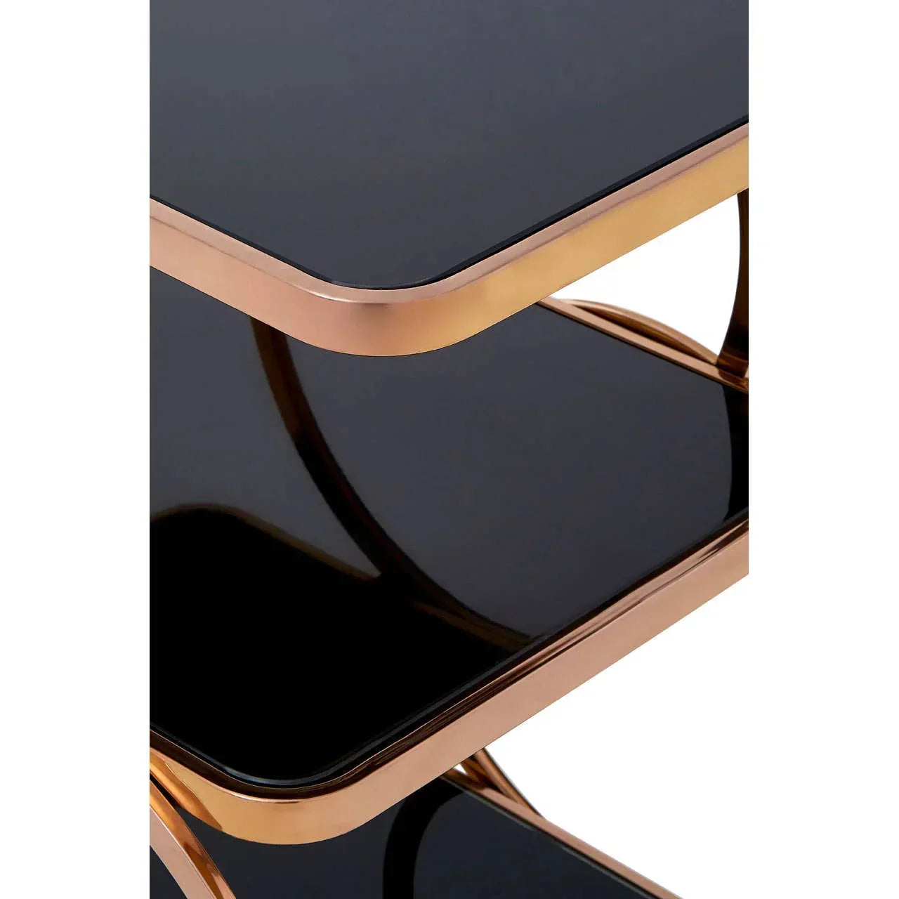 Close view of black glass side table shelves with gold metal frame and rounded corners