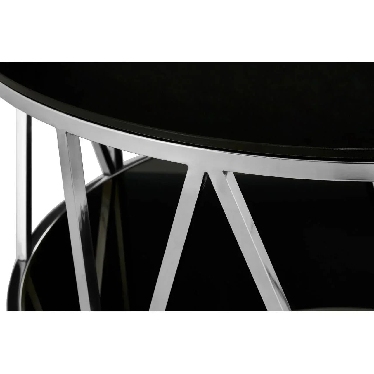 Closeup of round black glass coffee table with chrome metal legs