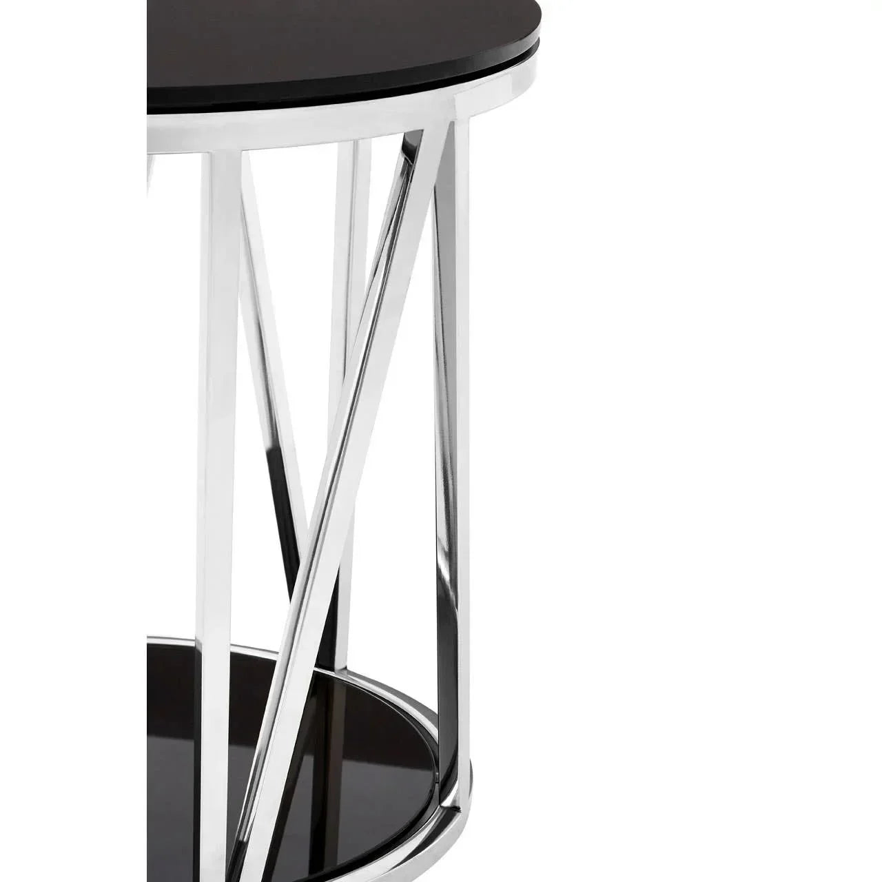Round side table with black glass top and chrome metal frame, close-up view