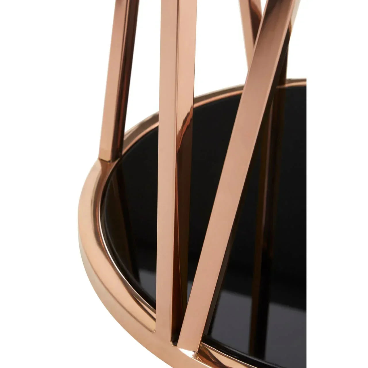 Close-up of modern coffee table legs in gold finish with black glass top