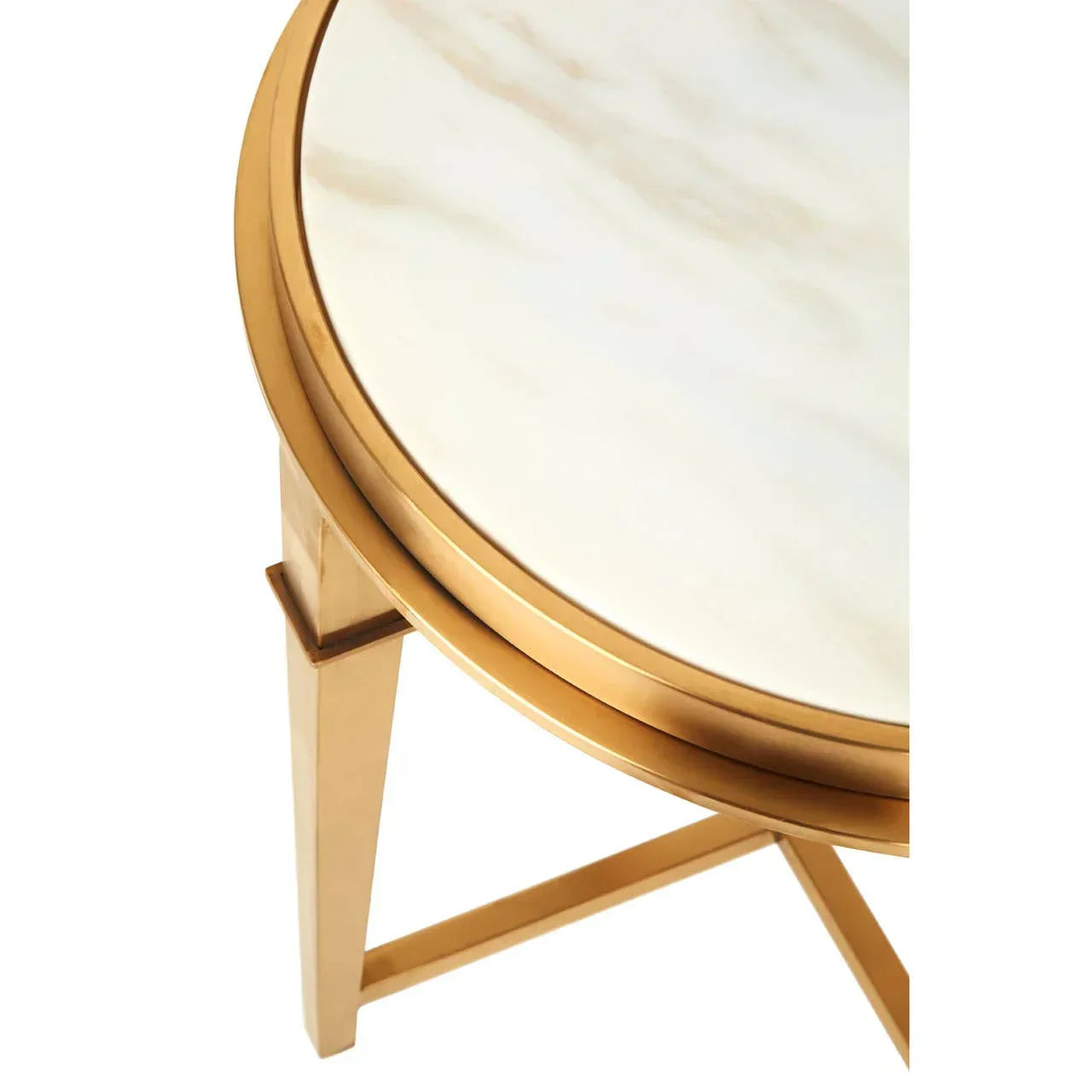 Round side table with white marble top and gold metal legs, close-up corner view