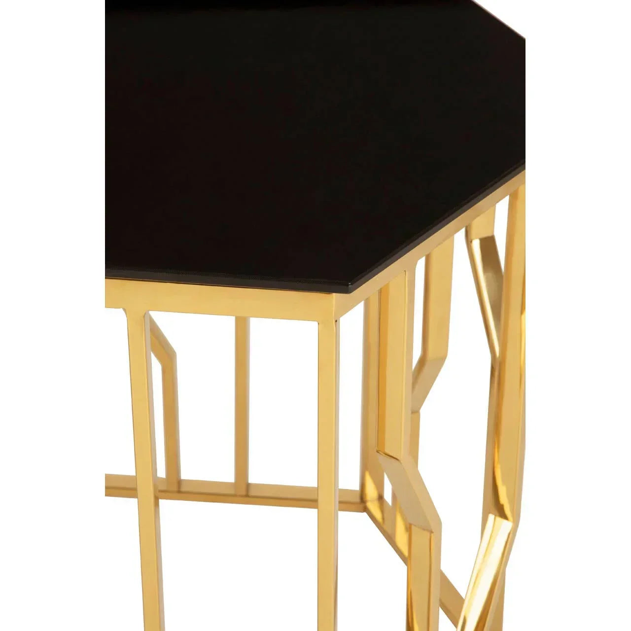 Black glass top side table with gold geometric metal frame, close-up corner view
