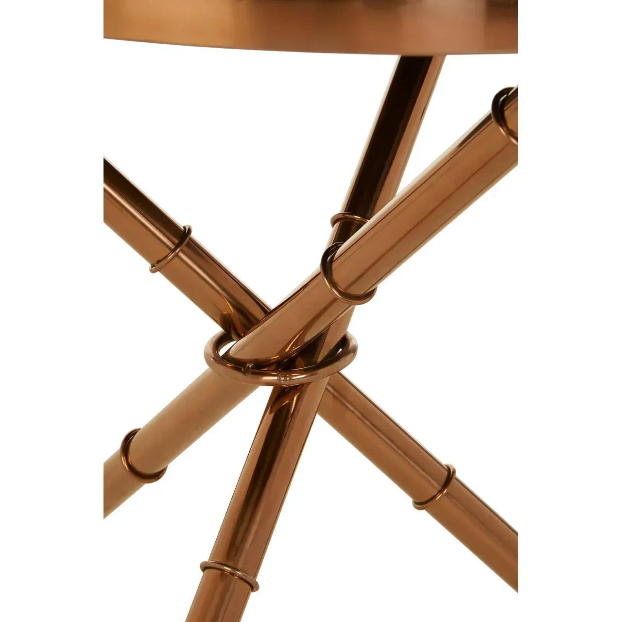 Copper metal table legs with circular detail, close-up view